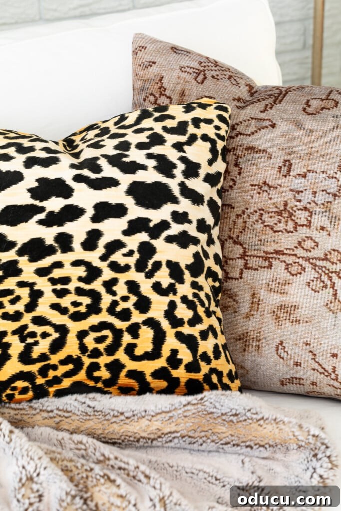 Remember That Essential Decorating Resource 3 Leopard fabric and woven pillow covers on a sofa in a living room decorated for fall.