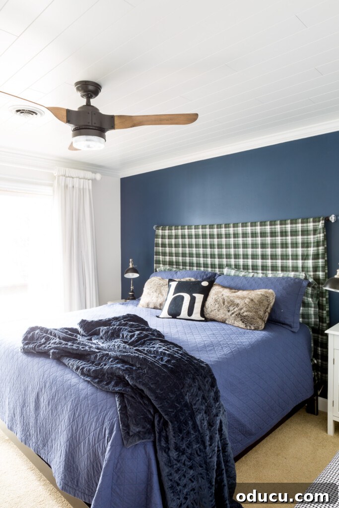 Reimagining the Blue Guest Oasis 2 Blue accent wall with plaid sheet made into a king size headboard.