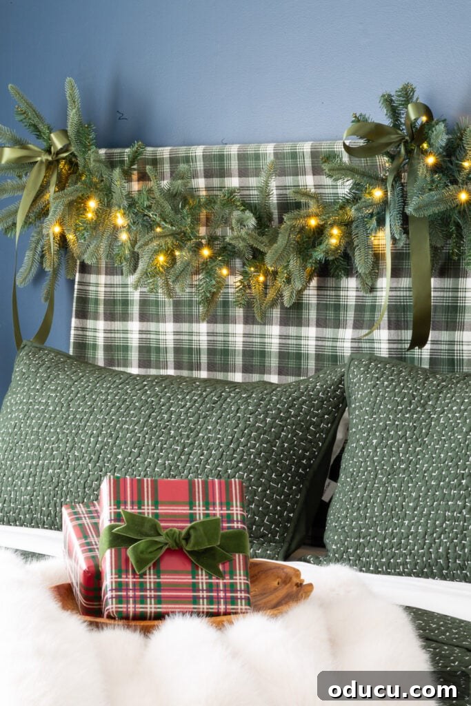 One King of Christmas Fir Set for Three Stunning Holiday Rooms 2 King of Christmas garland draped over bed headboard.