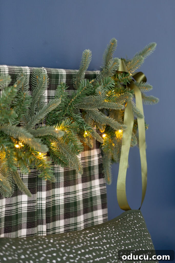 One King of Christmas Fir Set for Three Stunning Holiday Rooms 6 Bed headboard decorated for Christmas using a lit King of Christmas Noble Fir garland.
