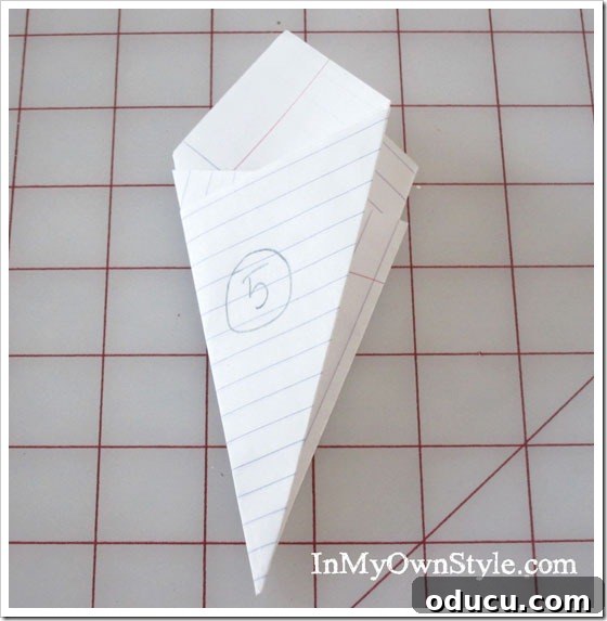 DIY Paper Snowflake Window Displays 10 Step 5: Final fold, matching edges for a compact paper snowflake base.