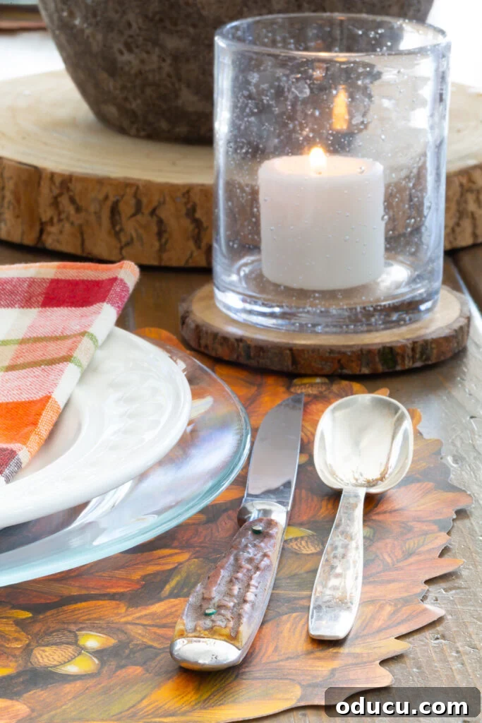 Thanksgiving's Functional and Festive Focal Point 2 A beautifully set Thanksgiving table showcasing a blend of textures in each item, centered around a simple, elegant centerpiece and paper placemats.