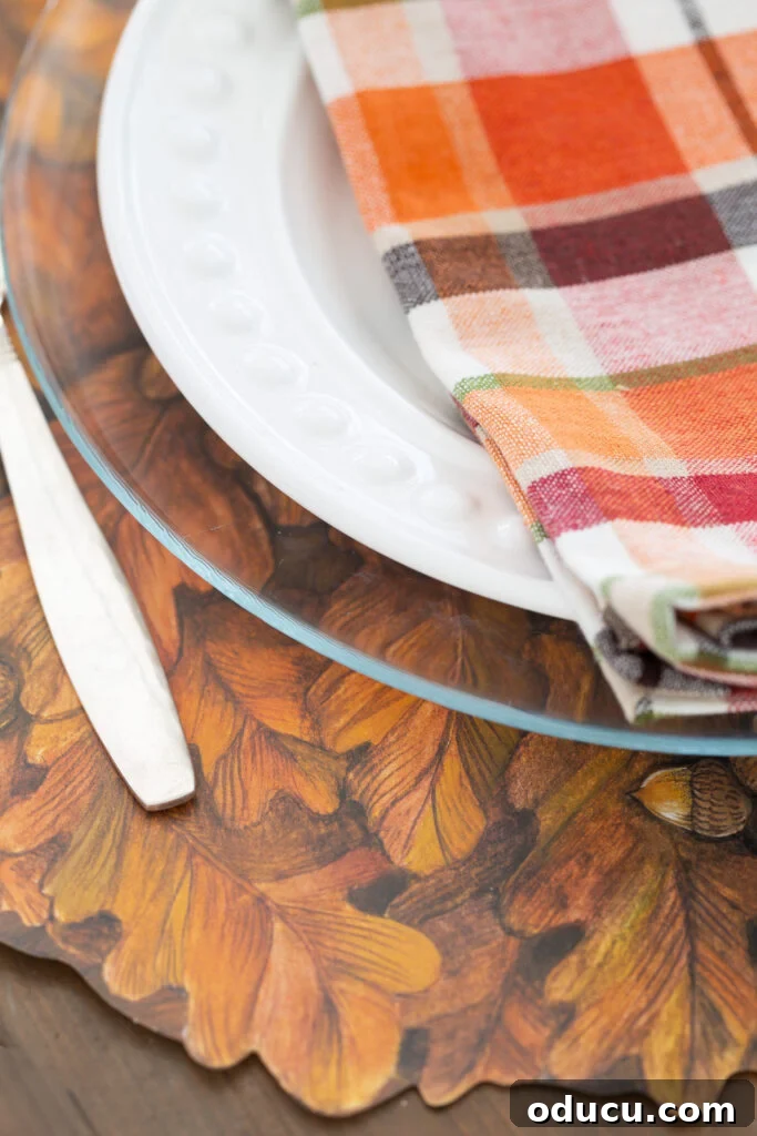 Thanksgiving's Functional and Festive Focal Point 11 Close-up detail of the intricately cut edge of the Autumn Wreath paper placemat by Hester & Cook, highlighting its quality.