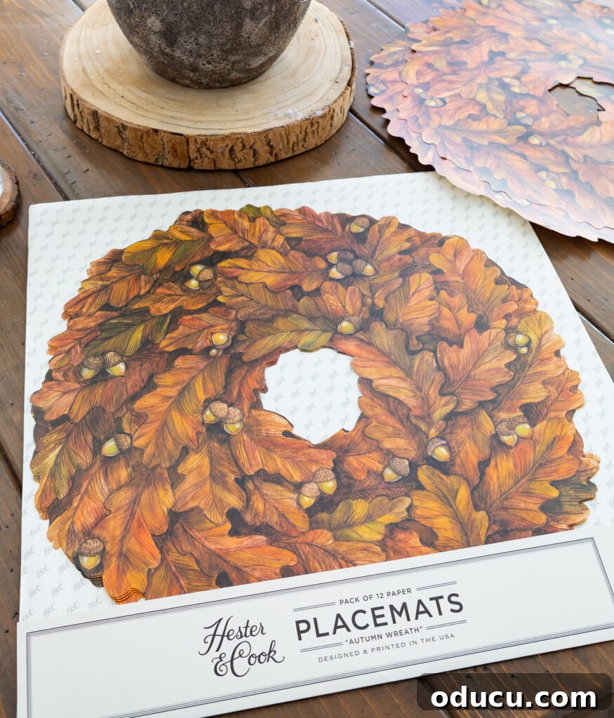Thanksgiving's Functional and Festive Focal Point 4 A package containing 12 'Autumn Wreath' paper placemats by Hester & Cook, ready for a festive table setting.