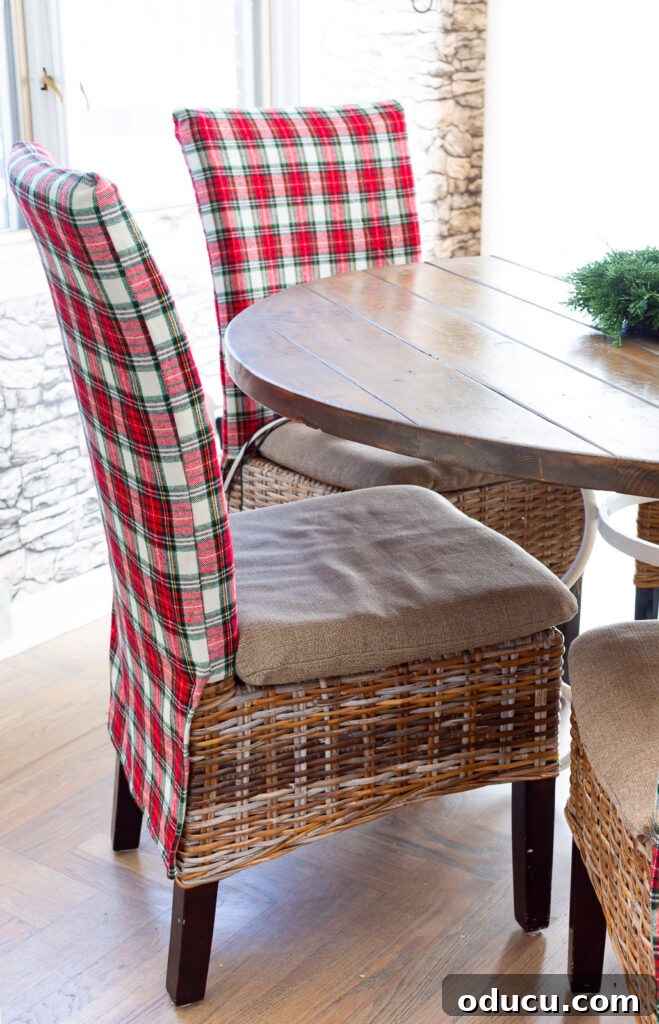 Looking at side of a holiday plaid covered dining chair as it sits around a dining table.