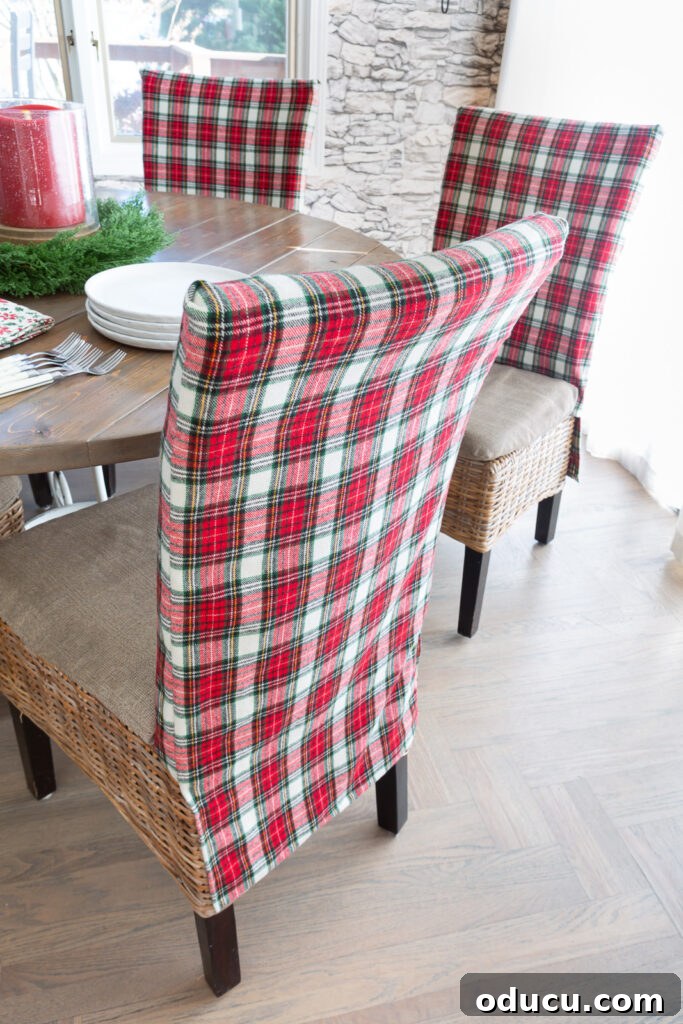 Looking at the back of one of the classic holiday plaid fabric covered dining chairs around a dining table.