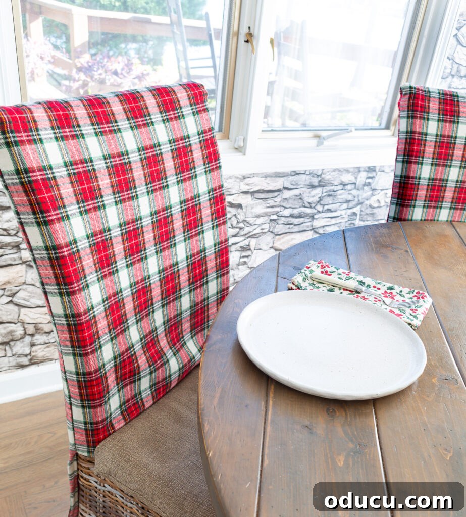 Red and white Christmas plaid fabric made into dining room chair back covers.