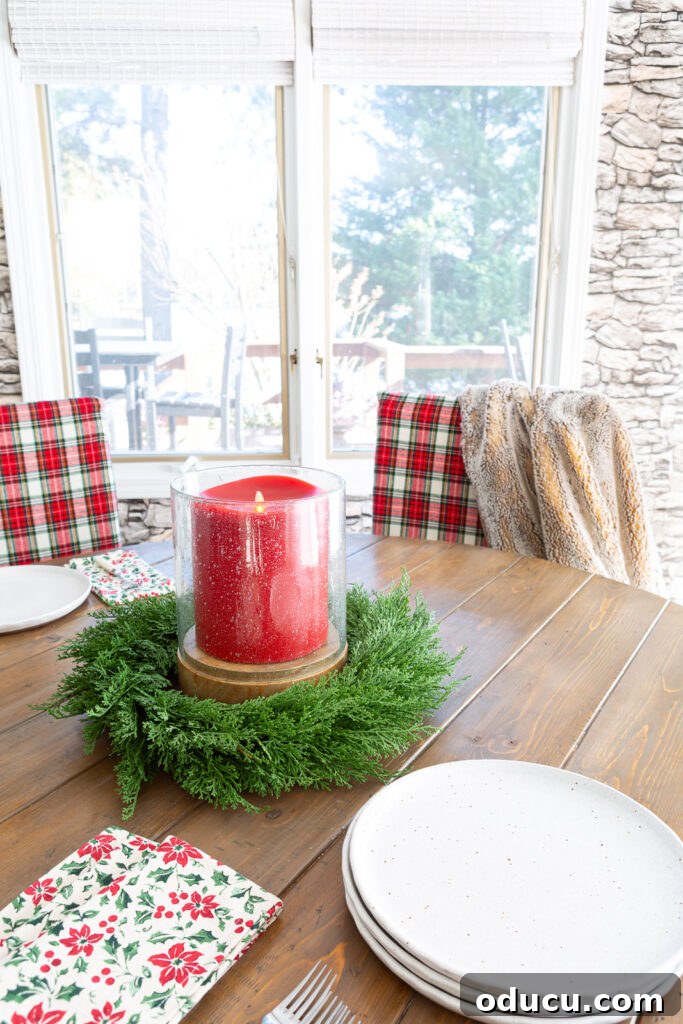 Looking at a round wood dining table with red and white Christmas plaid fabric covers on al the dining chairs.