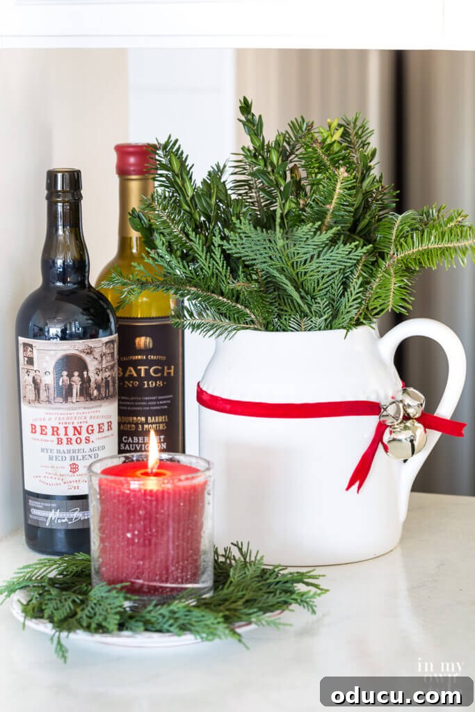 My Christmas Home: Timeless Memories, Not Trends 15 ribbon and jingle bell Christmas decoration on a white pitcher