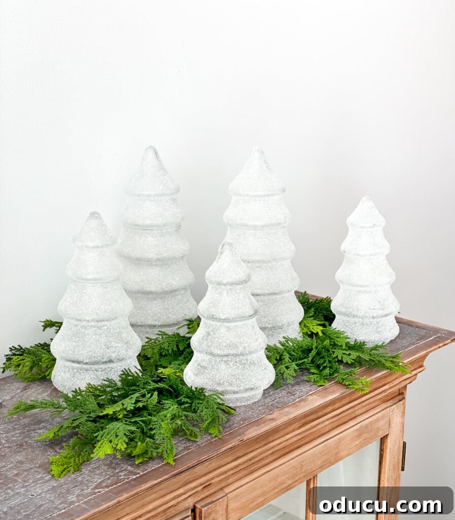 My Christmas Home: Timeless Memories, Not Trends 5 Christmas tree shaped glass jars displayed on a buffet