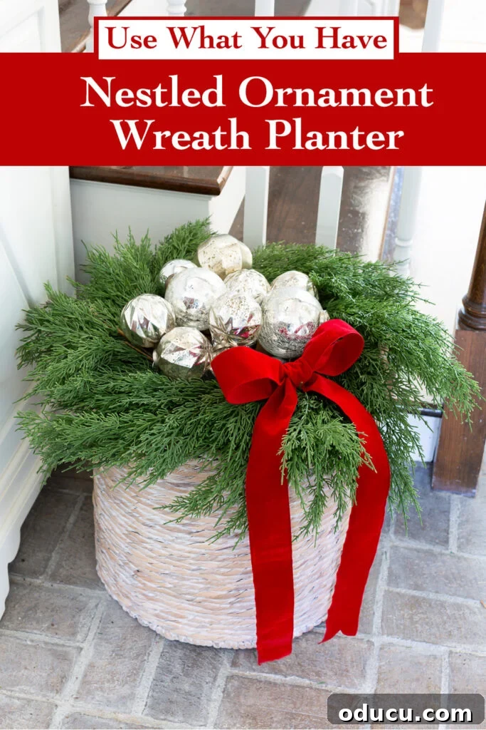 The Wreath Revelation You Need This Christmas 14 A beautifully arranged Christmas decoration featuring nestled silver ornaments within a wreath, placed on a decorative basket planter, showcasing easy and charming holiday style.