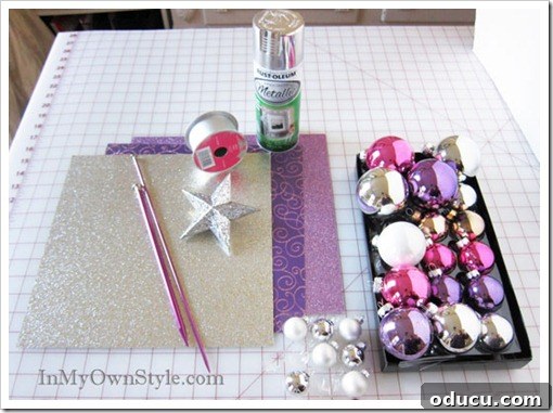 Supplies for Ornament Tree A flat lay of all the essential supplies needed to construct a knitting needle ornament Christmas tree, including ornaments and a knitting needle.