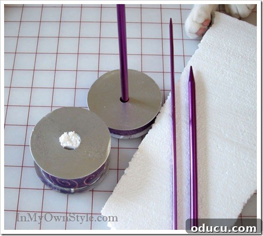 Securing Needle in Spool Knitting needles secured in ribbon spools with Styrofoam, demonstrating how to create a stable base for the tabletop ornament trees.