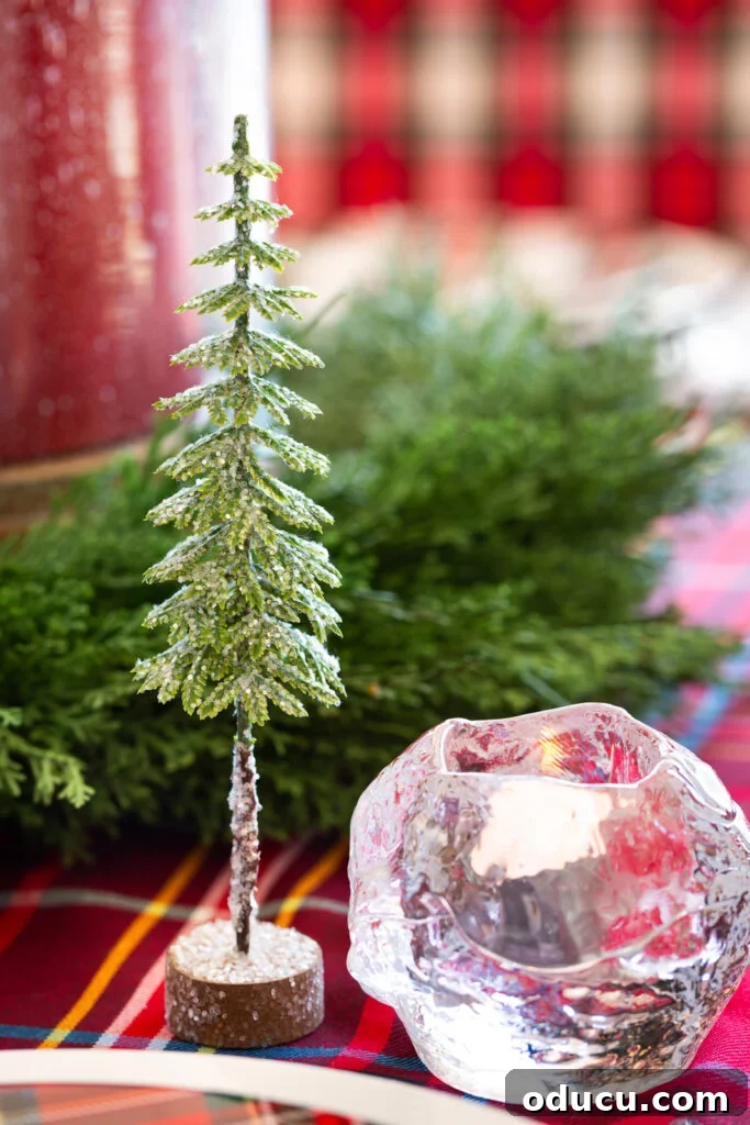 Style Scouting: Holiday Special (Vol. 273) 2 Cute glittered pine tree decoration from Hobby Lobby on table setting along with a Kosta Boda snowball votive holder.
