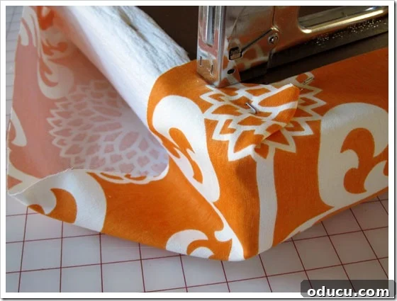 Achieving perfect fabric corners in no-sew upholstery. Folding and stapling the fabric corners like a gift package for a clean finish.