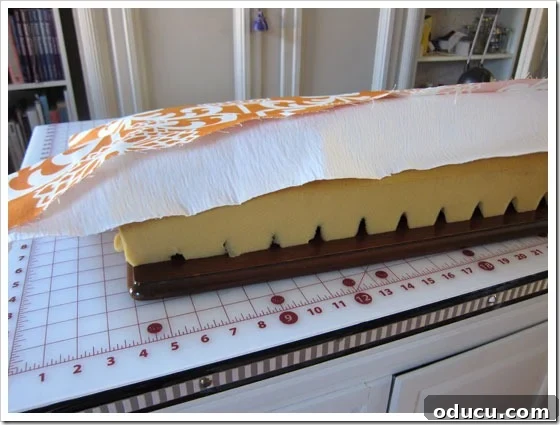 Visual guide to layering cushion materials for a no-sew project. Layering foam, lining fabric, and decorative fabric for a no-sew bench cushion.