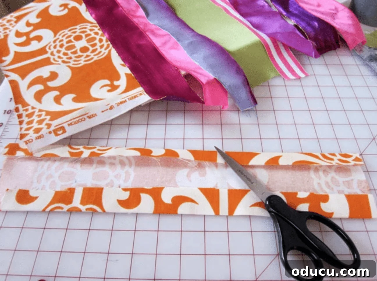 Craft Your Own Stylish Ribbon Memo Board 4 Ribbons being measured and cut on a craft mat, preparing for the memo board project