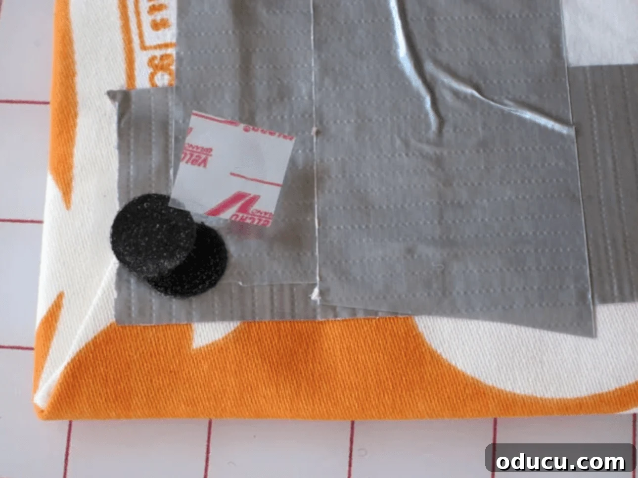 Craft Your Own Stylish Ribbon Memo Board 7 Applying Velcro dots to the back corners of the completed ribbon memo board for mounting