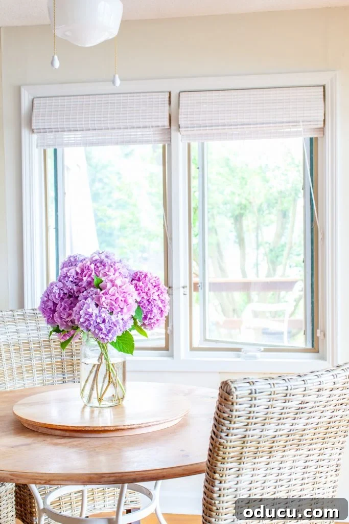 Smart Ways to Paint Window Trim Like a Pro 2 Just cut pink hydrangeas from the garden in a vase on a kitchen table.