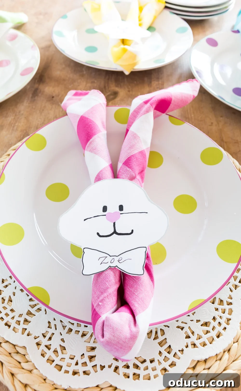 Pastel Pink Buffalo Check Napkin folded to make an Easter bunny napkin holder on a plate. Pastel Pink Buffalo Check Napkin folded to make an Easter bunny napkin holder on a plate.
