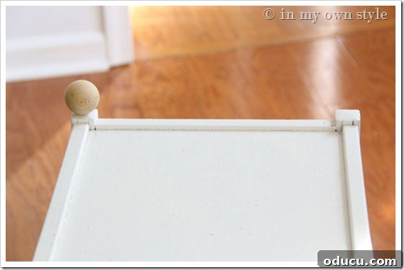 1-ball-attached on furniture edge Close-up of a single wood ball embellishment securely attached to a furniture edge.
