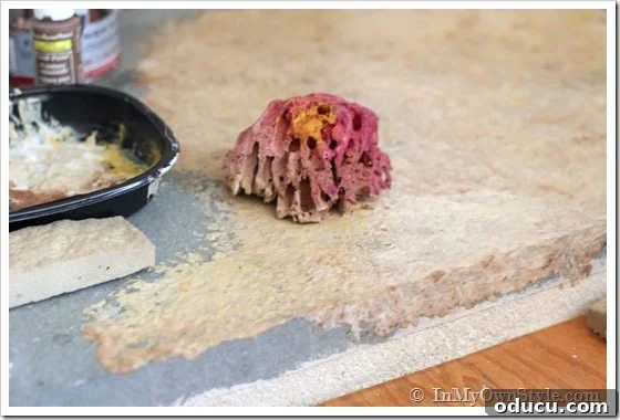 sea sponge used to paint grey concrete hearth