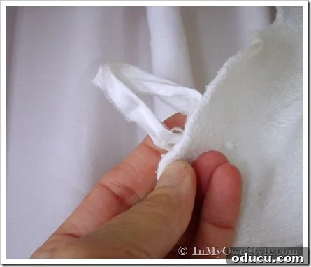 Bed-Loop-to-hang-side-panel Close-up of a neatly sewn ribbon loop, designed to hang a fabric side panel from the cornice headboard, ensuring easy installation and removal.