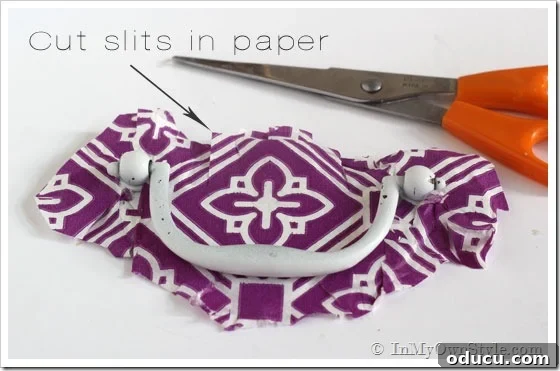 Cut-slits-in-paper How to update a brass drawer pull using paper napkins. Photo shows how to wrap the pull.