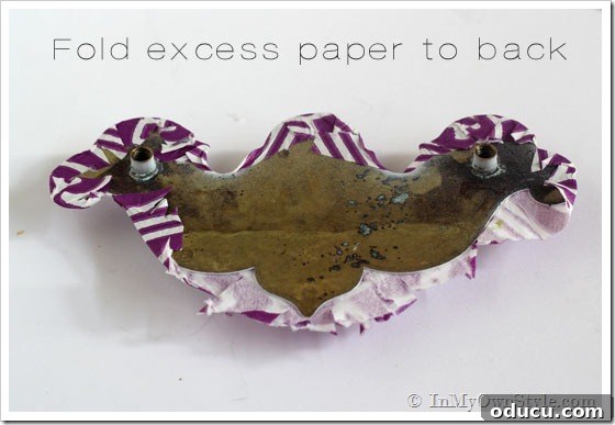 Fold-excess-paper-to-back How to update a brass drawer knob using glue and paper napkins. Shows folding tabs.