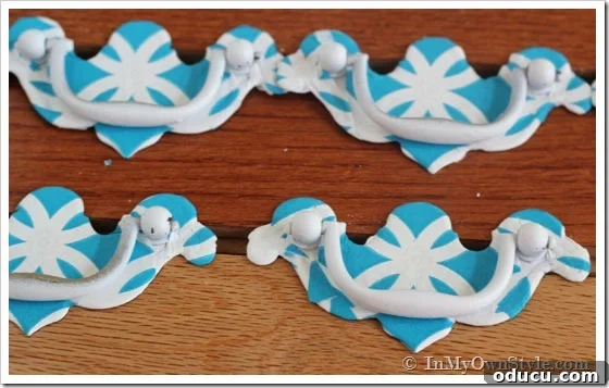 napkin-covered-pulls napkin-covered-drawer pull makeover showing finished pulls with turquoise and white printed napkins.