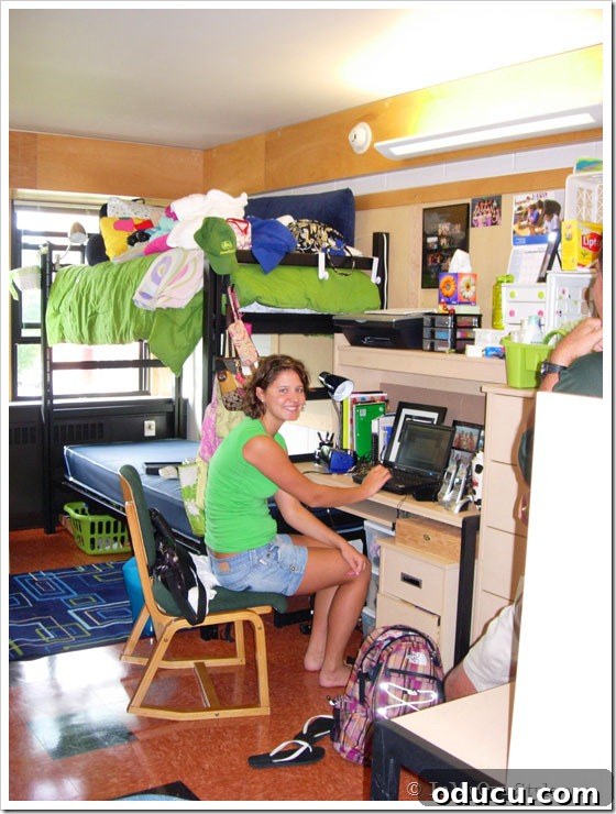 Stylish Dorm Room Decor for Less 4 Dorm Decorating Ideas. Student sitting at desk in messy dorm room