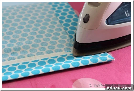 No Sew hem being created on fabric edge.