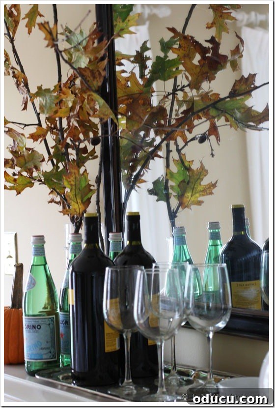 FAll Mantel Decorating Ideas Autumn-themed mantel decor in a dining room, featuring natural branches and a chalkboard.