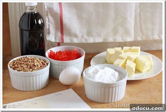 Essential Ingredients for Christmas Cookies Ingredients for Pecan Cherry Dunking Cookies laid out on a surface.