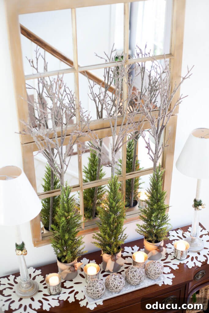 Foyer in home decorated for Christmas with silver branches, pine and felt snowflake mats.