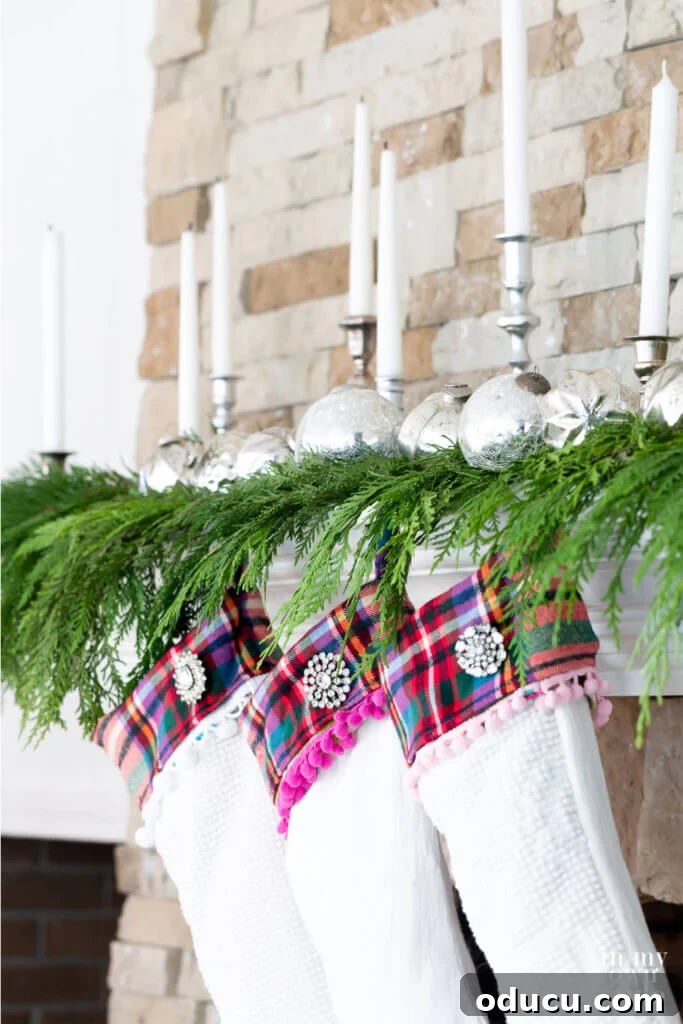 White Plaid trimmed Christmas stockings hanging from a fireplace mantel.