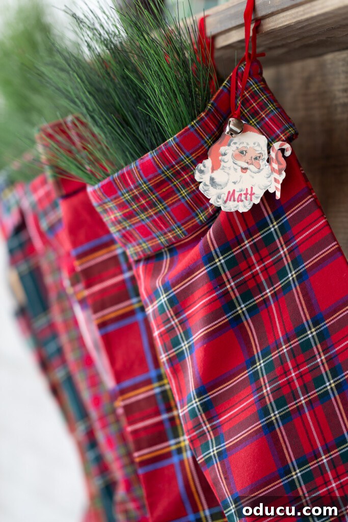 Craft Your Own Christmas Stocking Guide 2 A line up of red plaid Christmas stockings hanging on a wood mantel.