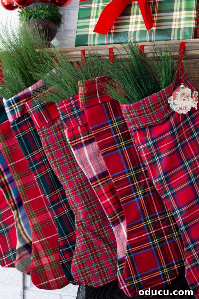 Craft Your Own Christmas Stocking Guide 4 red plaid handmade stockings hanging from a wood mantel.