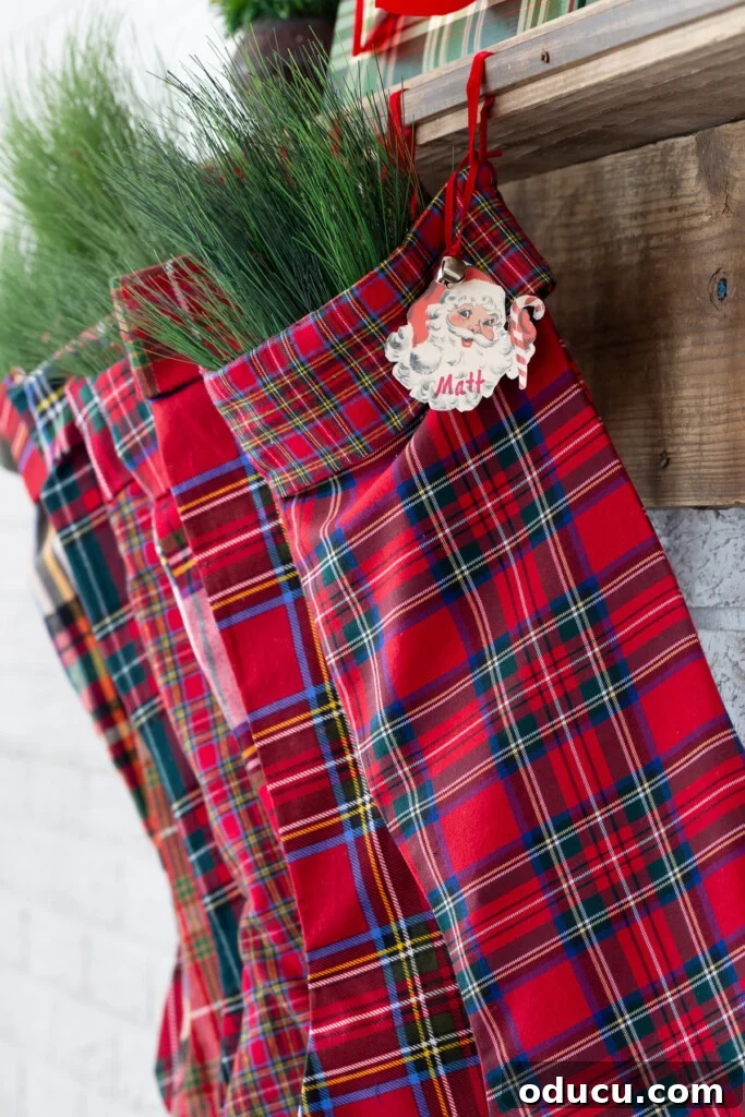 Craft Your Own Christmas Stocking Guide 5 DIY Fabric red plaid handmade stockings hanging from a wood mantel.