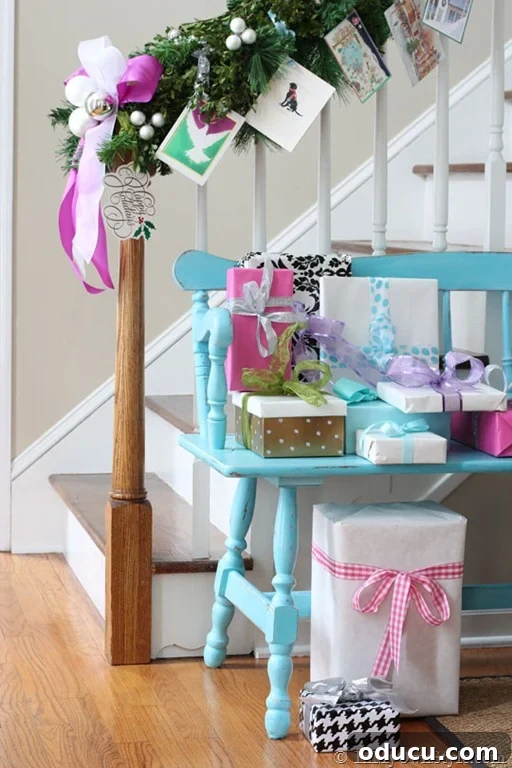 The Christmas House 2 Christmas garland with tied cards draped on a staircase railing, featuring a turquoise bench with wrapped Christmas presents in the hallway.