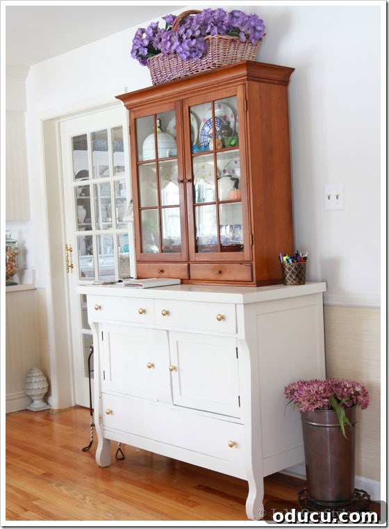 Furniture Reimagined 5 Furniture placement ideas: A glass-front cabinet stacked on a painted sideboard, creating visual balance between kitchen and family room.