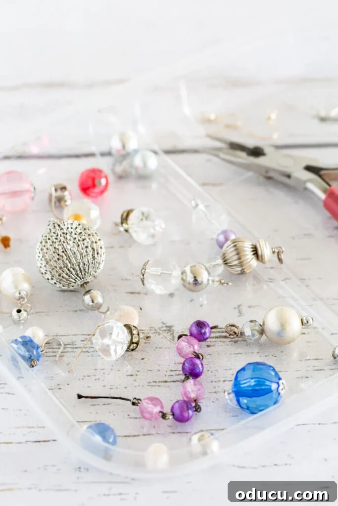 Craft Stunning Drop Dangles 5 beads to make earrings spread out on a clear tray.
