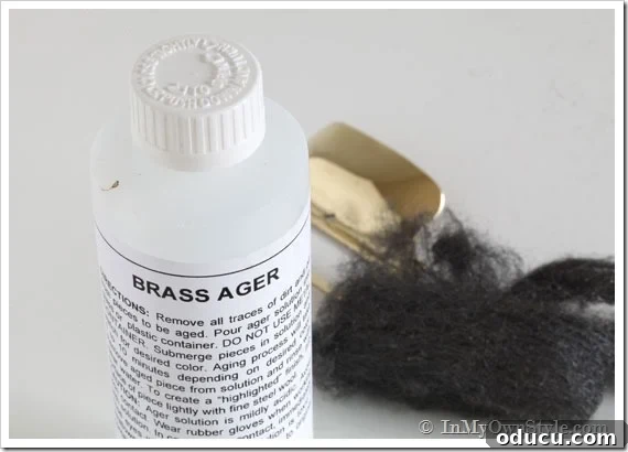 Instant Brass Patina: A 5-Minute Method 7 Brass Ager solution in a container with steel wool nearby, demonstrating the materials for brass aging.