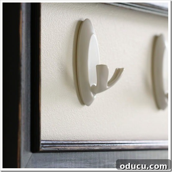 3M-Mudroom-Double-Hooks-White Side view of Command Brand Double Hooks being installed on a wall for mudroom storage.