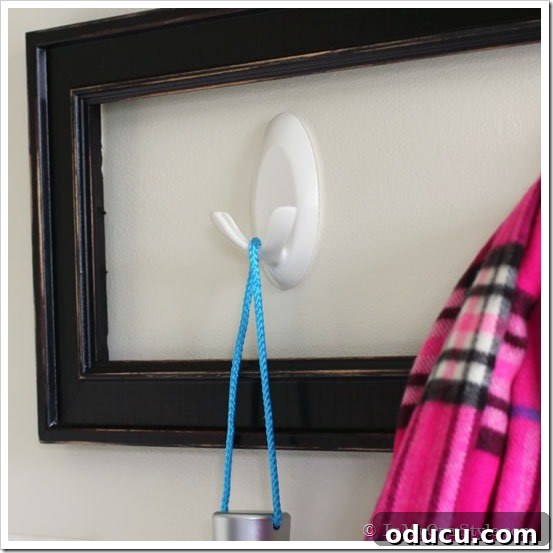 clever ways to decorate a mudroom Mudroom wall organizing ideas featuring three white Command Brand Double Hooks installed on the wall, ready for use.