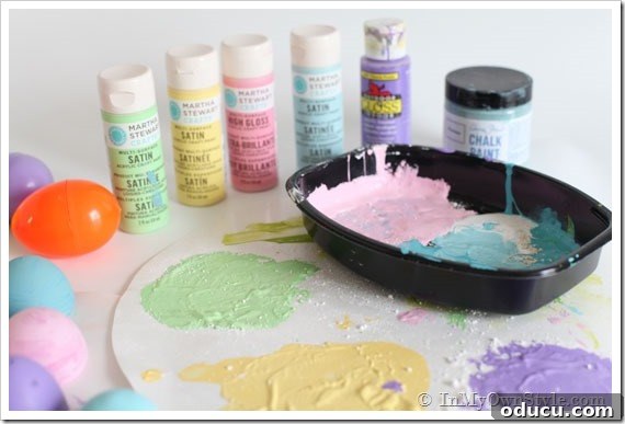 DIY Chalk Paint Easter Egg Decorating Steps Close-up of plastic Easter eggs being painted with DIY chalk paint, showing the initial coating process for decorating.