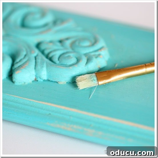 Applying Detailing Wax to Chalk Paint Close-up of detailing wax application on decorative molding of a chalk-painted towel rack.