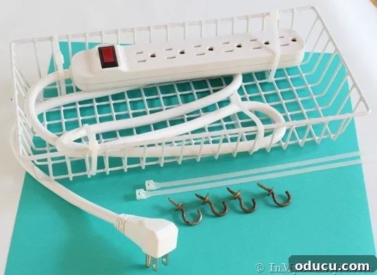 Clutter-Free Desk: DIY Cable Management 3 White wired basket with a power strip secured inside using zip ties