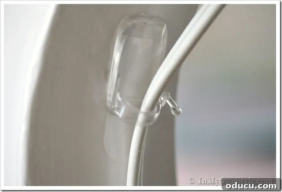 Clutter-Free Desk: DIY Cable Management 7 Clear cord organizers attached to a desk leg for managing cords