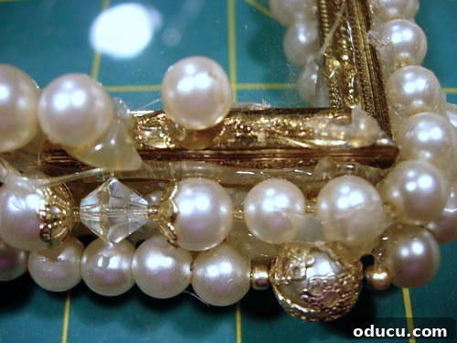 Transform Vintage Frames into Unique Necklace Gifts 2 Prepping an old photo frame for a DIY pearl necklace transformation.